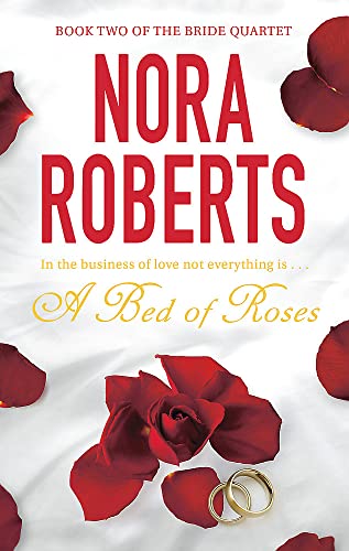Book cover with red roses, wedding rings, and large red text: Nora Roberts.