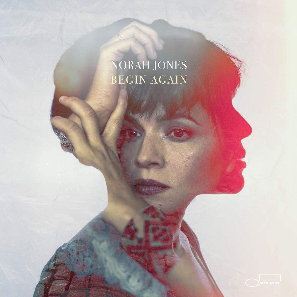 Album cover of Norah Jones' "Begin Again" featuring a woman's double-exposed profile.