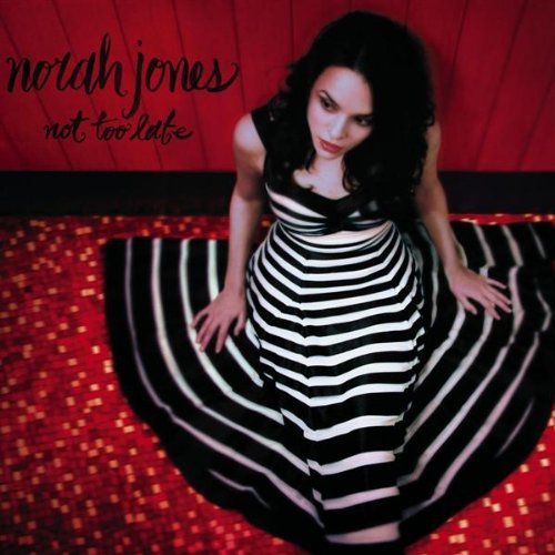 Norah Jones album cover, featuring her in a striped dress on red.