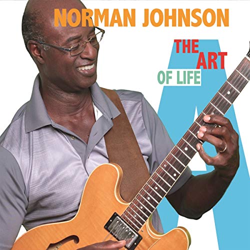 Norman Johnson smiling with a guitar, album cover for "The Art Of Life.