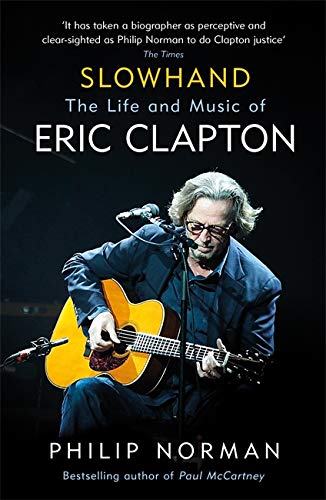 Book cover: “Slowhand” biography of Eric Clapton playing guitar.