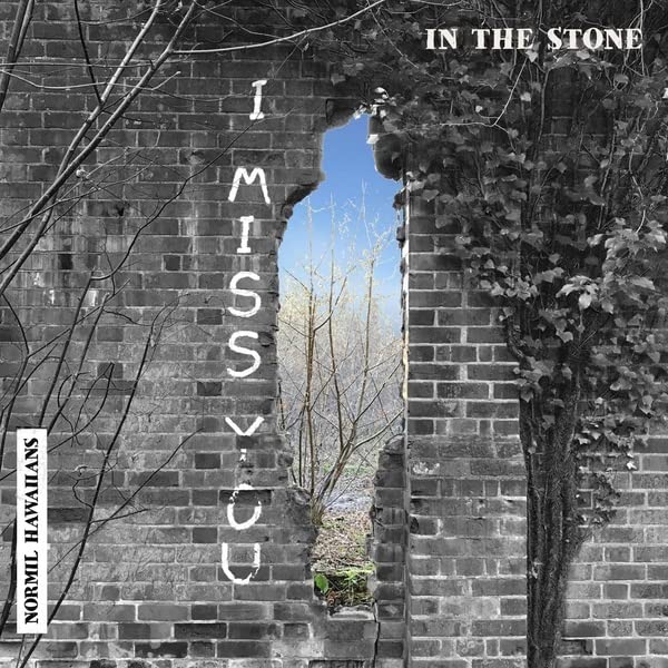 Record cover: brick wall with an arched opening to a blue sky.