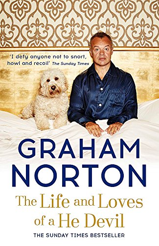 Graham Norton sits with a dog on a gold and white patterned background.