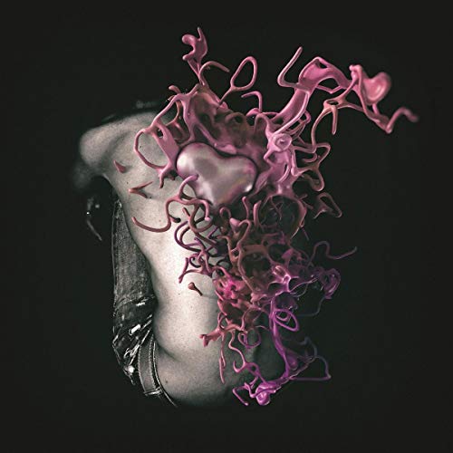 A hand holds a pink, abstract, heart-shaped object with tendrils against a black background.