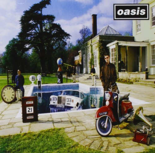 Oasis “Be Here Now” album cover with band members and vintage objects.