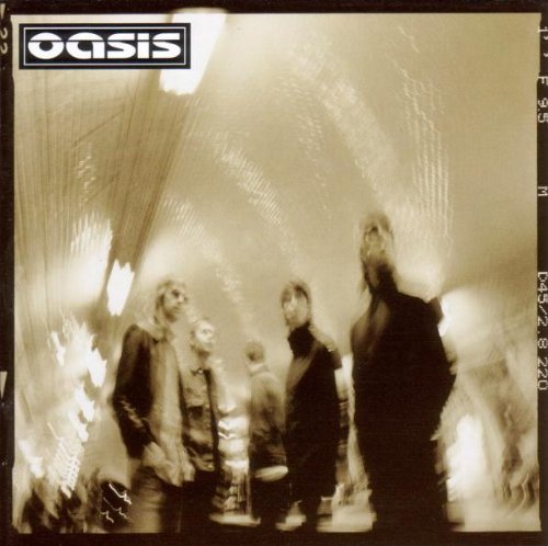 Black and white Oasis album cover with band members in a blurred, tunnel-like setting.