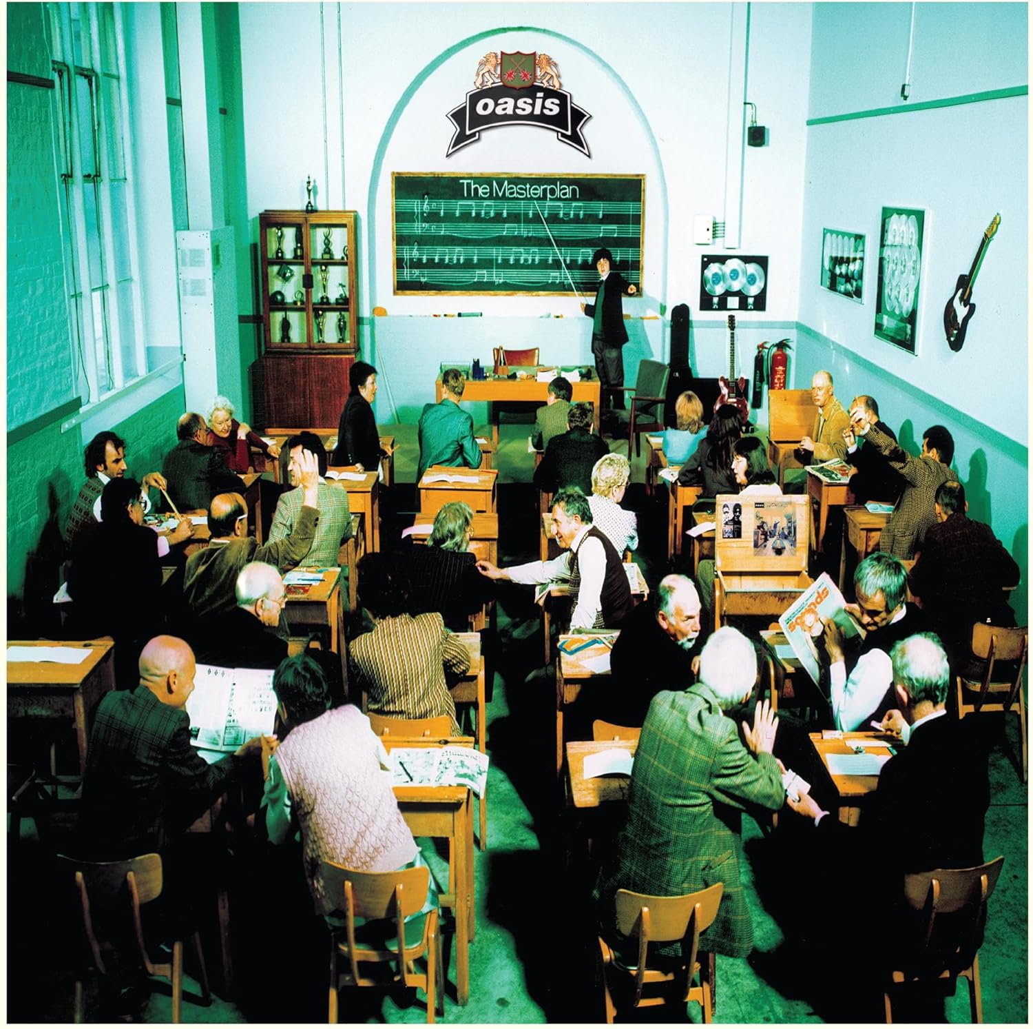 Oasis’ “The Masterplan” album cover: a classroom scene with people.