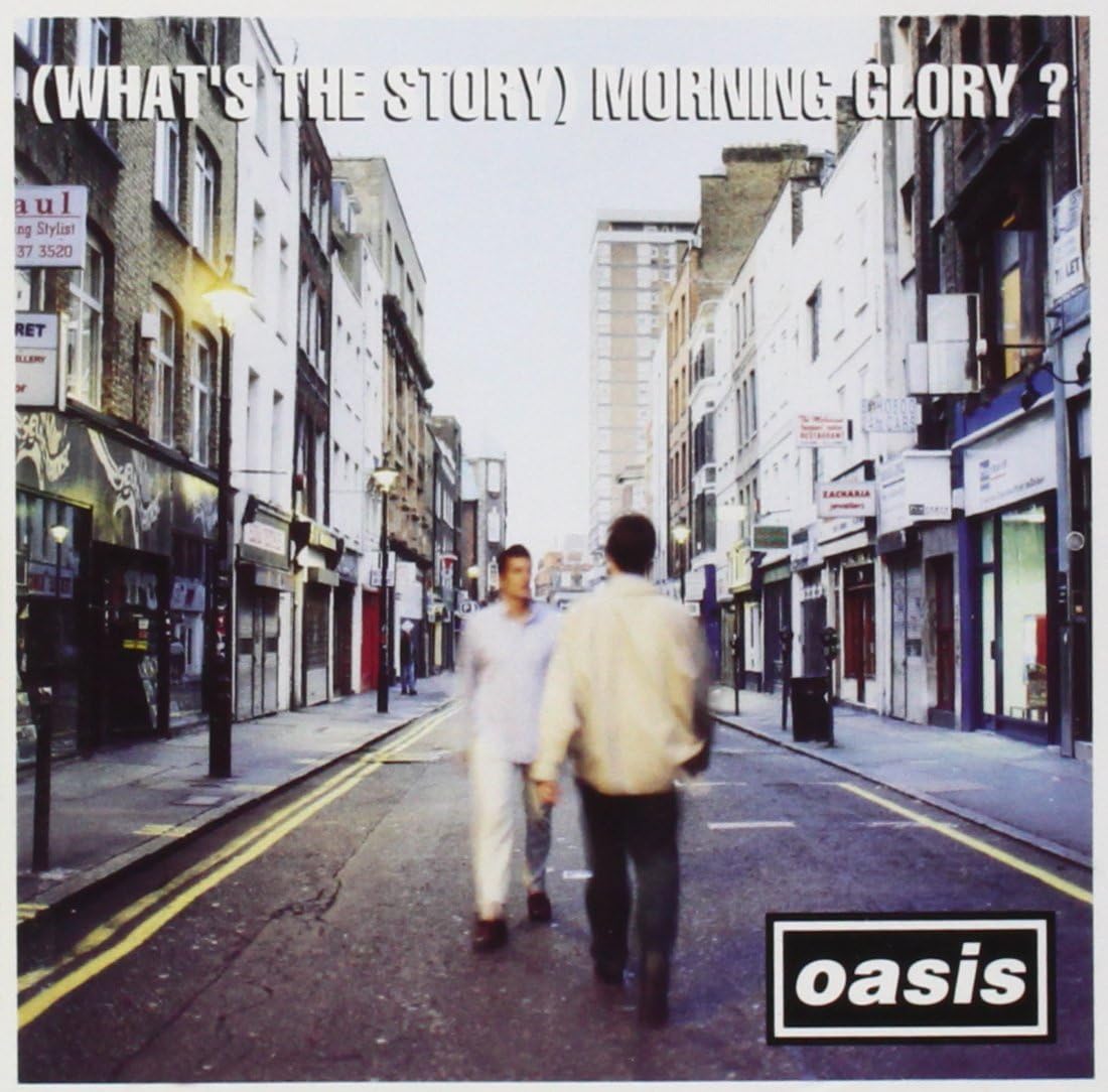 Oasis album cover: two blurred figures walking down a city street.