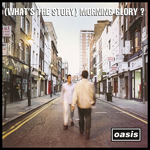 "Album cover featuring two men walking down a street, with 'Oasis' logo in the corner."