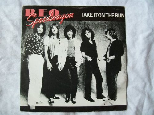Black and white photo of a five-member band, REO Speedwagon.