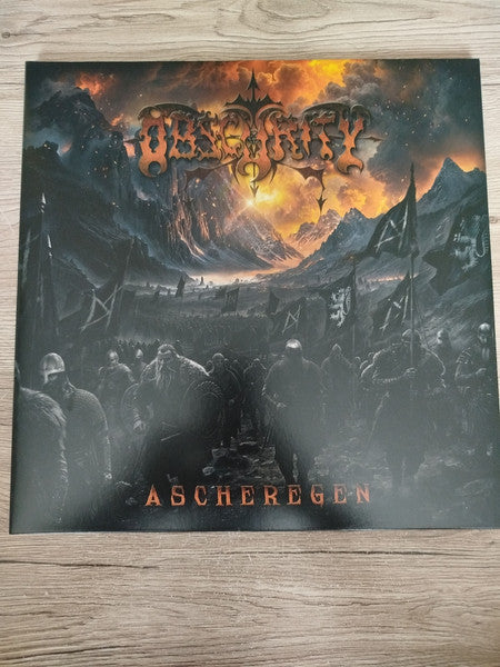 Black vinyl record cover with dark fantasy landscape and band logo.