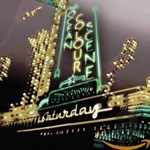 Bright neon sign spelling “Ocean Colour Scene Saturday” over dark amusement park.