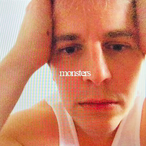 Close-up portrait of a man with the word "monsters" overlaid.