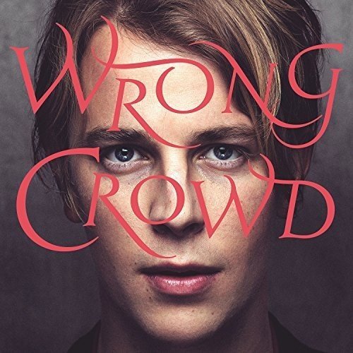 "Tom Odell's album cover with his face and 'Wrong Crowd' in red text."