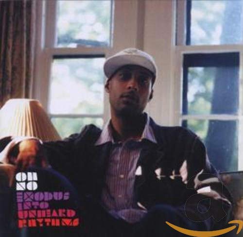CD cover featuring a man in a hat, seated indoors.