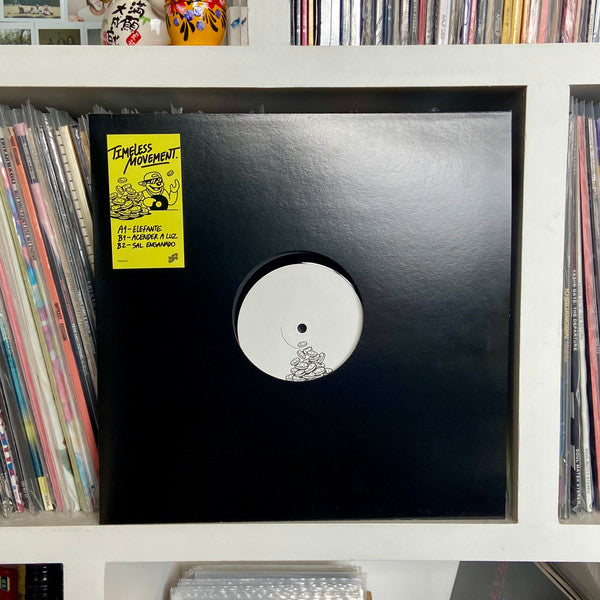 Black vinyl record with yellow label featuring cartoon illustration.