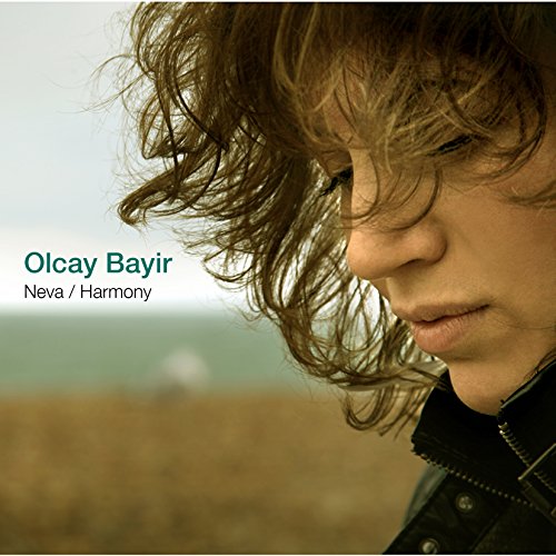 A woman with messy brown hair and black jacket on a music CD cover.