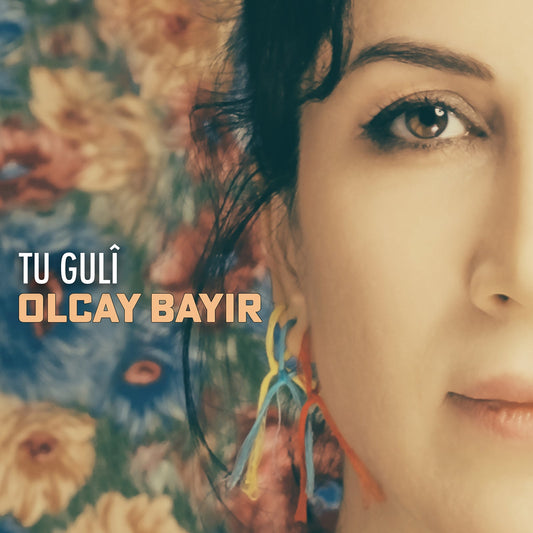 CD cover featuring a close-up portrait of Olcay Bayir with floral background.