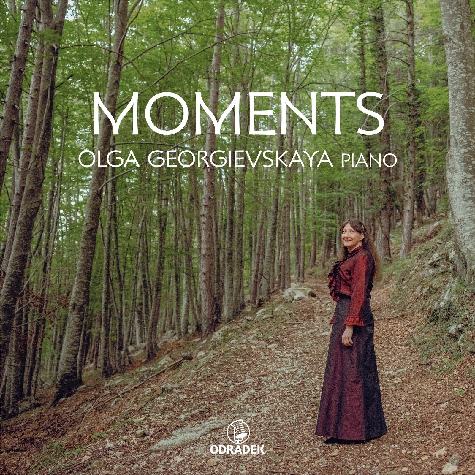 CD cover: Olga Georgievskaya with piano, forest background.