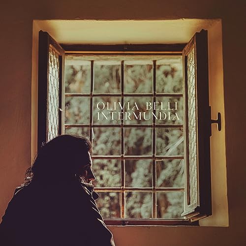 A person looks out an open window with the text Olivia Belli Intermundia overlaid.