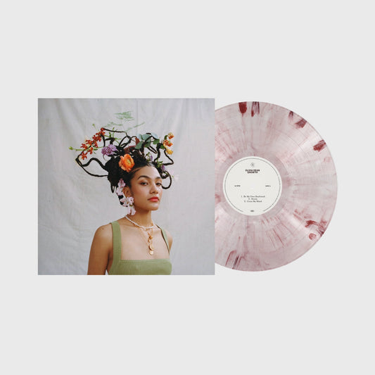 Pink marble vinyl record with a woman adorned with flowers on the cover.