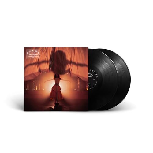 Olivia Dean vinyl record cover showing a performer on stage with two black discs.