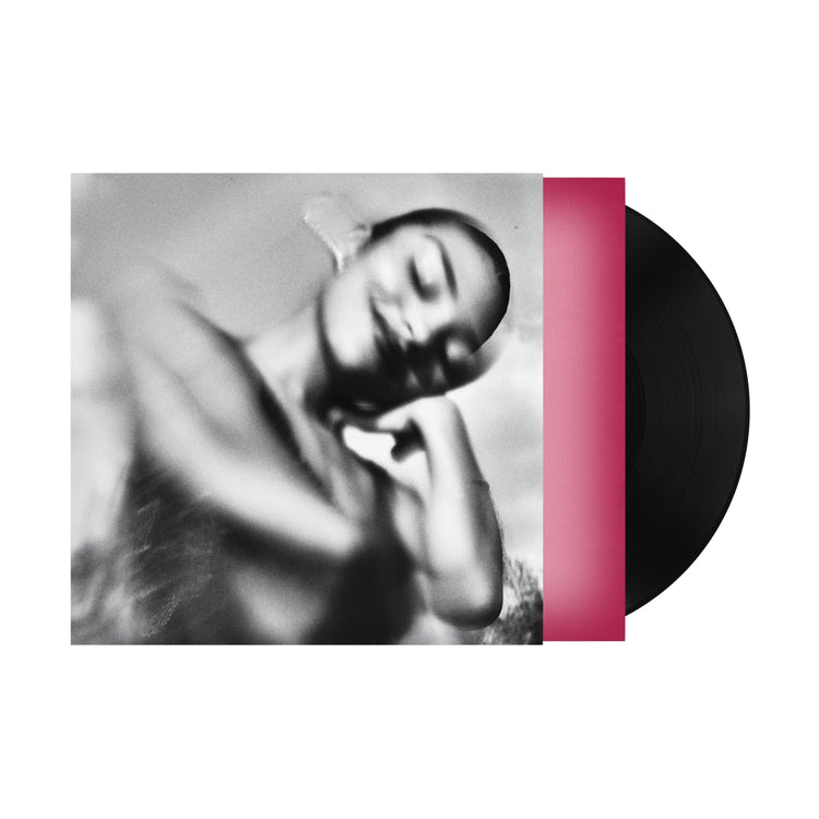 Black and white portrait of Olivia Dean on a vinyl record sleeve with pink accent.