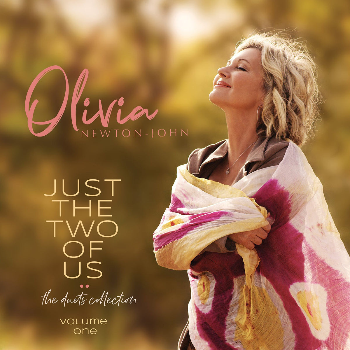 "Olivia Newton-John album cover featuring her portrait with a shawl, outdoors."
