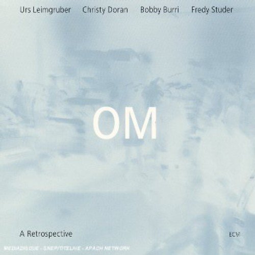 "CD cover with 'OM' in white on a light blue, cloudy background."