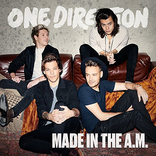 One Direction album cover featuring four band members on a couch.