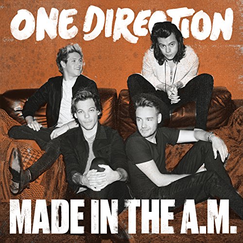 The four members of One Direction sitting on a couch against an orange background.