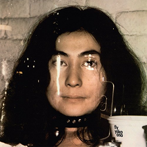 Yoko Ono’s “Fly” CD cover: close-up portrait with white streaks on face.