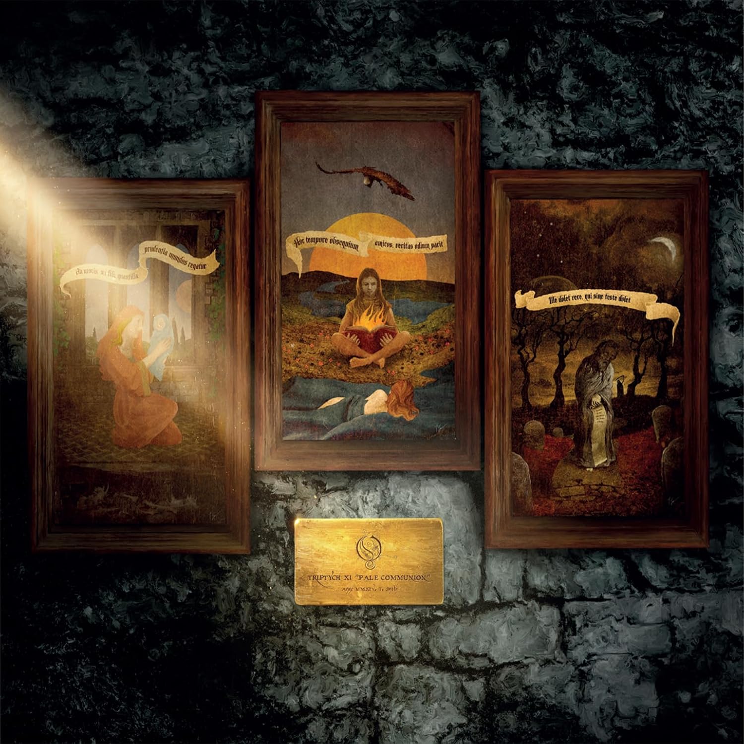 Three framed paintings on a stone wall with a golden plaque below them.