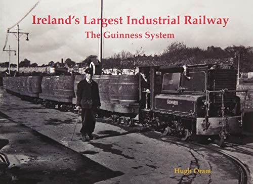 Black and white photo of a Guinness railway train with a worker.