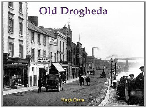 Black and white street scene of Old Drogheda, Ireland, with vintage cars.