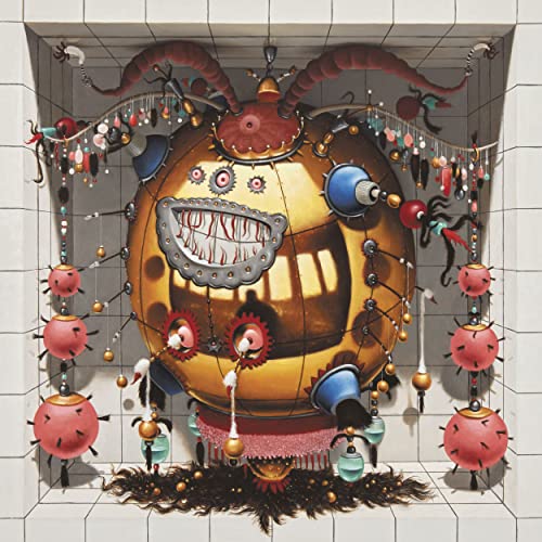 Album cover: a bizarre, golden sphere with a grinning face and dangling ornaments.