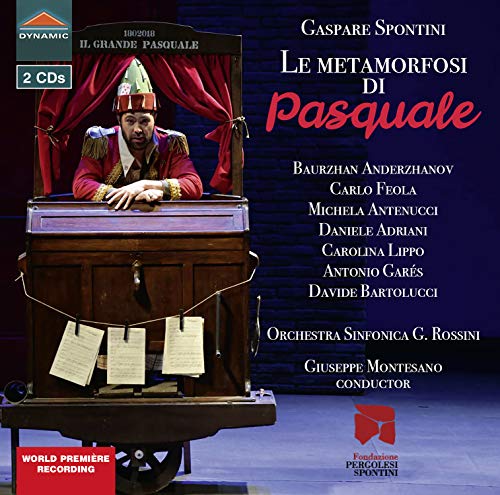 A performer in a red costume stands inside a wooden cart on stage.