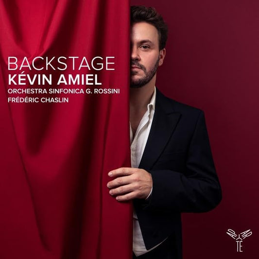 CD cover: Man in suit partially hidden behind red curtain.
