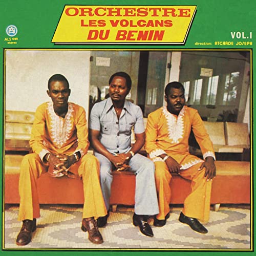 Vinyl album cover featuring three men in matching outfits seated outdoors.