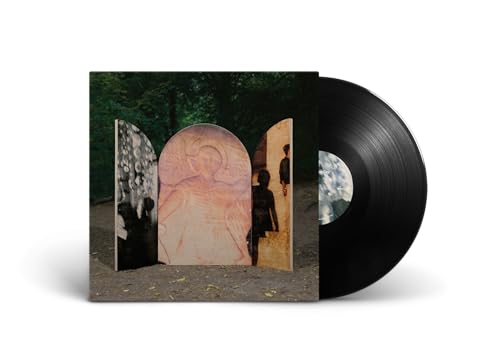 Black vinyl record next to album cover featuring three arched panels in a forest.