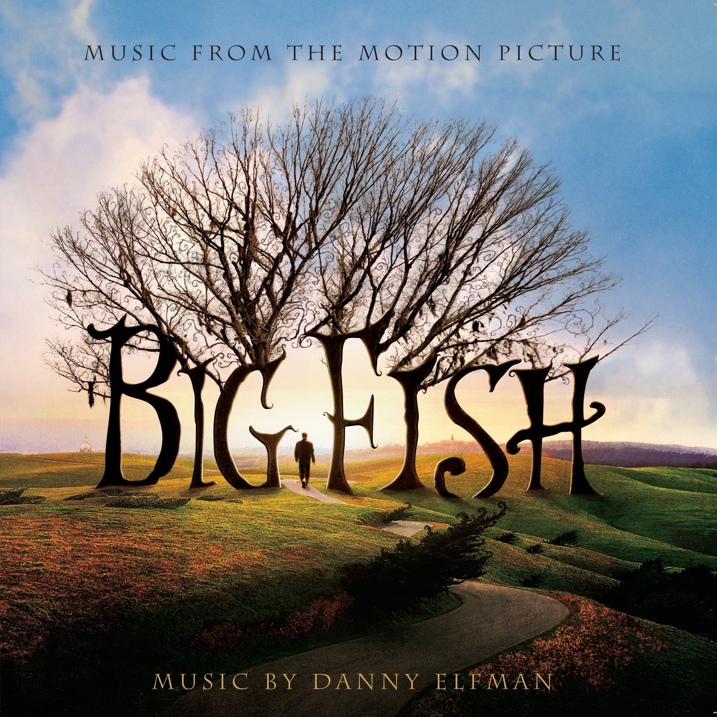 A man walks on a path toward a large tree shaped like Big Fish letters.