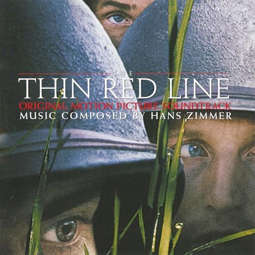 Close-up of soldiers in helmets partially obscured by tall grass, with film title text.