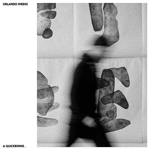 Black and white album cover with blurred figure and abstract shapes.