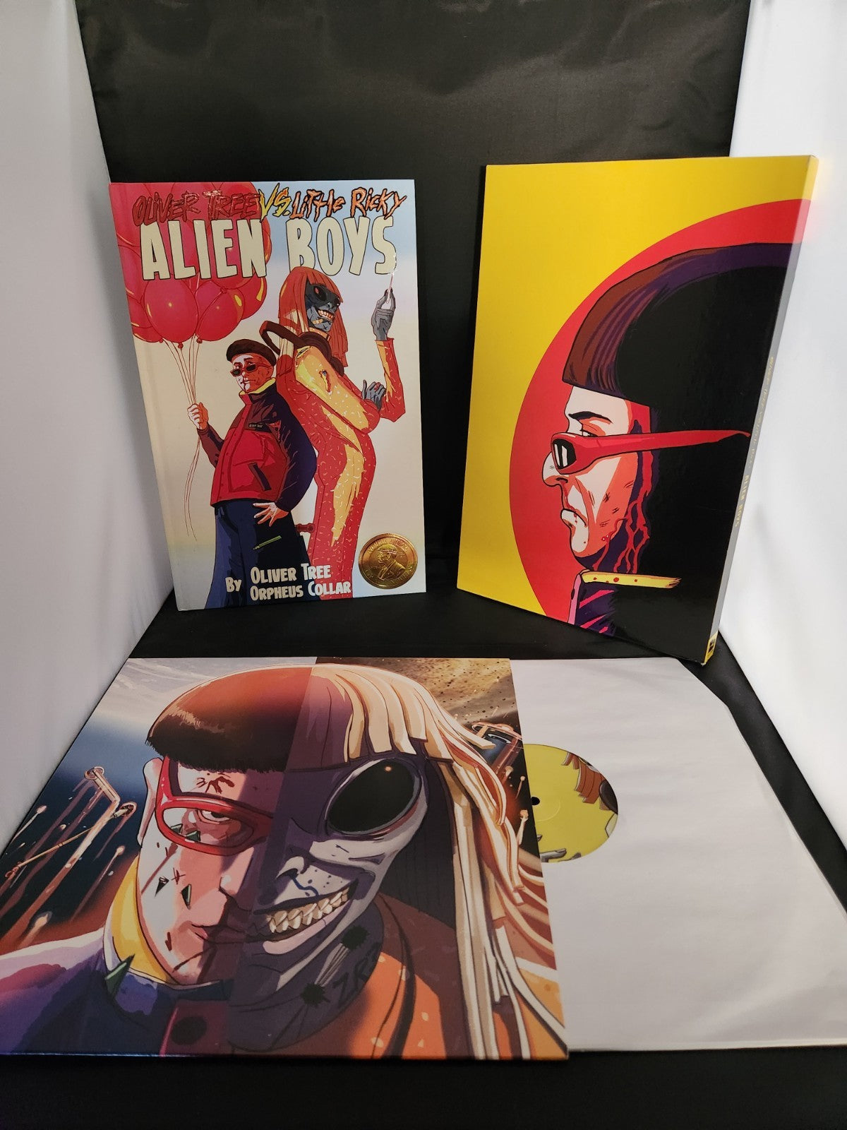 “Alien Boys” deluxe edition book with colorful cartoon illustrations.