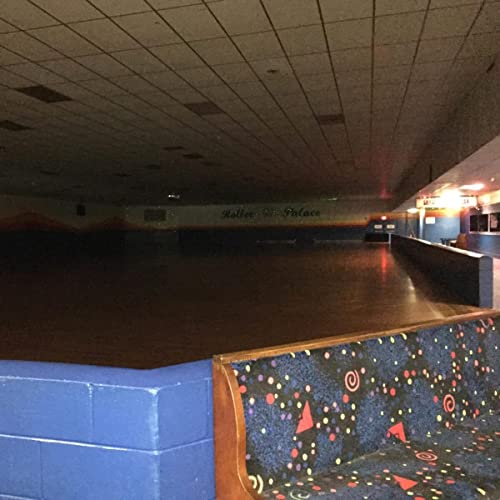 Empty roller skating rink with a patterned bench in foreground.