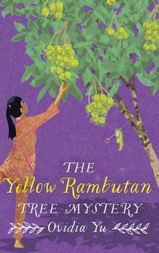 Girl reaching for yellow rambutan fruit hanging from a tree.