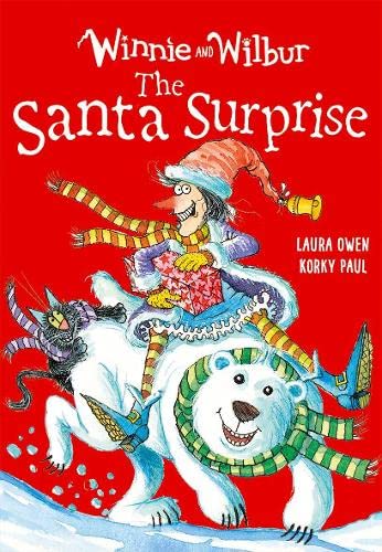 Winnie and Wilbur ride a polar bear with a black cat and Santa hat.