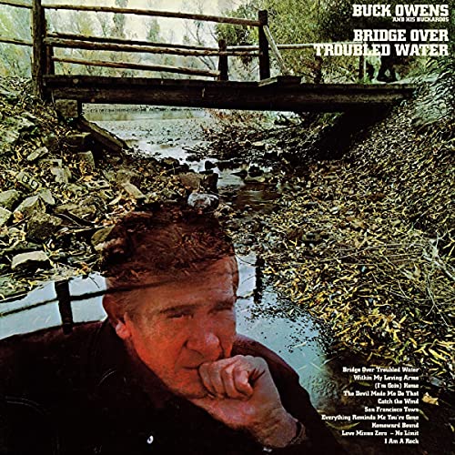 Album cover: Buck Owens portrait with a small wooden bridge reflection.