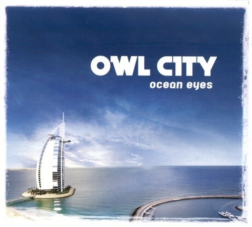 Owl City “Ocean Eyes” CD cover with a sail-shaped building by the sea.