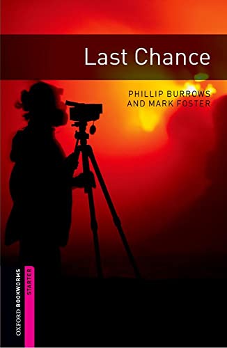 Book cover: silhouette of a person with a camera against a sunset.